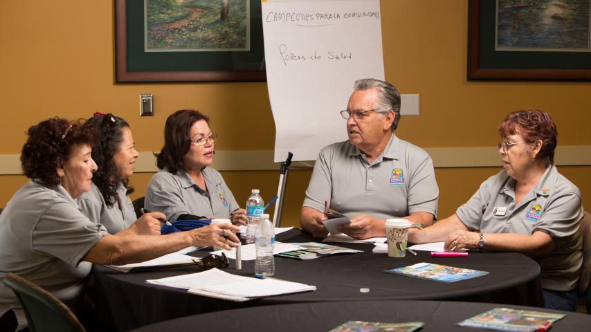team having a discussion around a table