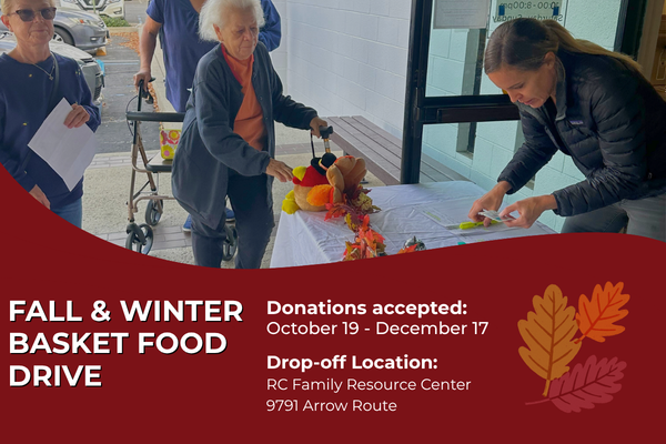 Holiday Food Basket flyer featuring a photo of individuals standing near a table inside a building. One individual is signing paperwork on a table decorated with autumn leaves and a small seasonal centerpiece. Large white text reads 'Holiday Food Basket.' A red curved section at the bottom includes text stating 'Fall & Winter Basket Food Drive,' donation dates from October 19 to December 17, and the drop-off location at RC Family Resource Center, 9791 Arrow Route. Decorative fall leaves appear on the right 
