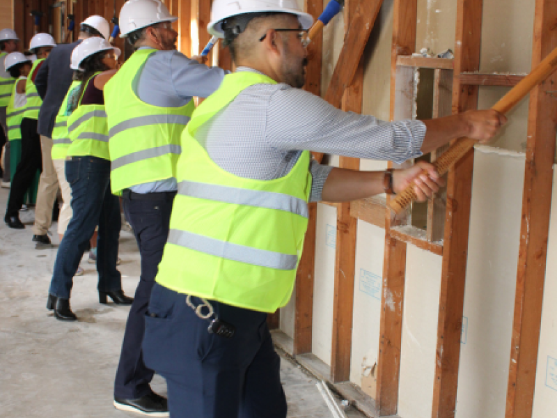 WSLEP construction photo of board members and staff wall demo