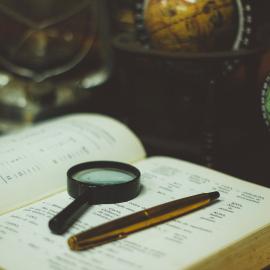 Image of book with magnifying glass