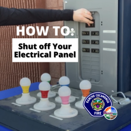 Firefighter demonstrating how to shut off electrical panel 